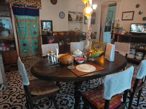 a dining room with a table with food on it at Rose Villa Colonial Heritage Bungalow, Takdah in Takdāh