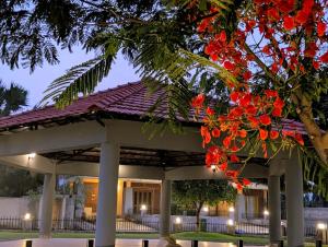 a gazebo with red flowers on it at Ketaki Homestay in Shānti Niketan