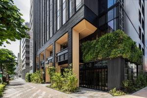 an office building with ivy on the facade at Caption By Hyatt Kabutocho Tokyo in Tokyo
