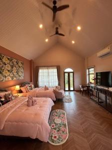 a bedroom with two beds and a ceiling fan at Campson Heaven Resort in Khao Kho