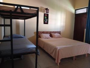 a bedroom with two beds and a bunk bed at Samee Villa & Hostel Airport in Seeduwa
