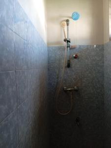 a shower with a shower head in a bathroom at Samee Villa & Hostel Airport in Seeduwa +13 photos