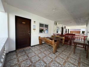 een kamer met een bank, een tafel en een deur bij KNB West Villa Inn by SMS Hospitality in Bolinao