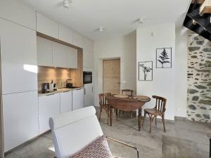 a kitchen and dining room with a table and chairs at La Clède du PontNeuf in Valleraugue