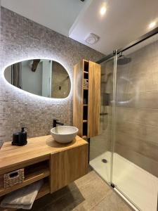 a bathroom with a sink and a shower at La Clède du PontNeuf in Valleraugue +16 photos