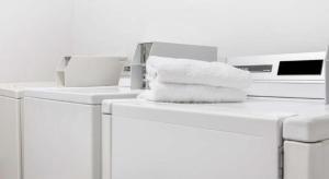 a pile of towels sitting on top of washing machines at Ramada Limited Norfolk in Greenwich