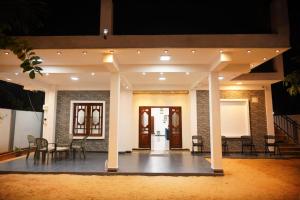 a lobby with chairs and tables in a building at Dilithy Paradise in Trincomalee