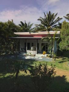 a house with a palm tree in front of it at Lanta Vacation House in Ko Lanta