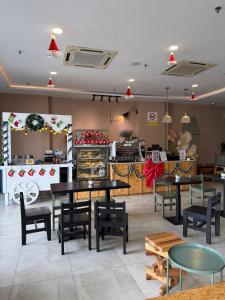a restaurant with tables and chairs and a counter at Mikayla Suite in Kota Bharu