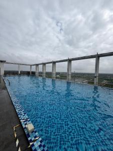 a large swimming pool on top of a building at Mikayla Suite in Kota Bharu