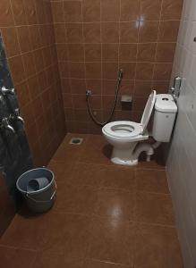 a bathroom with a toilet and a trash can at RAIAl DWELLING PLACE in Calangute