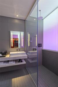 a bathroom with a tub and a sink and a mirror at Wink Hai Phong Centre, Unscripted by Hyatt in Hai Phong