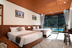 En eller flere senge i et værelse på Tam Coc Sweet Shelter Bungalow