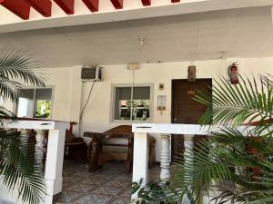 een woonkamer met een tafel en een raam bij KNB West Villa Inn by SMS Hospitality in Bolinao