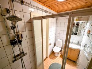 a small bathroom with a toilet and a shower at Host Harmony 6 PP Cabin Close to lake in Vittsjö +33 photos