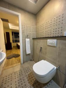 a bathroom with a toilet and a sink at The Panoramic Centauras in Islamabad +7 photos