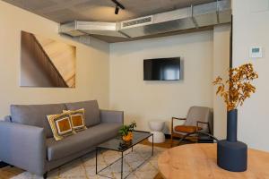 a living room with a couch and a table at BUBU Apartments By Exclusive Homes in Málaga
