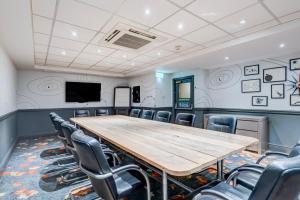a conference room with a wooden table and chairs at Manchester Portland By Sunday in Manchester