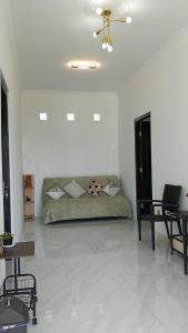 a living room with a couch and some tables at Micko Homestay, Mantrijeron "Top Rated Value" in Yogyakarta