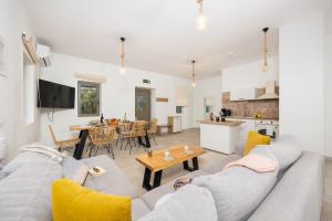 a living room with a gray couch and a table at Villa Castillo Ena in Agios Nikolaos
