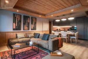 een woonkamer met een bank en een tafel bij Résidence l'Oxalys in Val Thorens