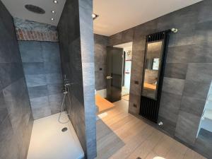 two views of a bathroom with a shower and a mirror at Charles in Verbania +31 photos