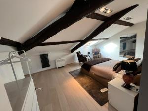 a bedroom with a bed in a room with wooden beams at Charles in Verbania