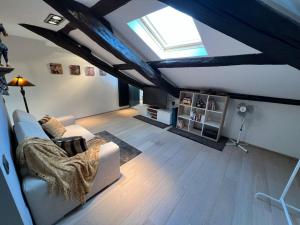 a living room with a white couch and a window at Charles in Verbania