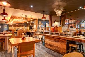 a restaurant with tables and chairs and a bar at Manchester Portland By Sunday in Manchester
