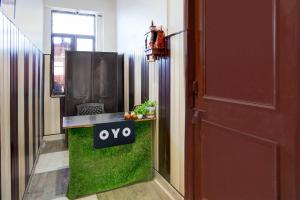 a entrance to a room with a tv and a door at Hotel O Govind Guest house in Jhājra