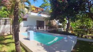 a villa with a swimming pool and a house at Designer Villa "Sunset Hills" with Pool in Puerto Princesa City
