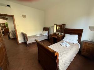 a bedroom with two beds and a mirror at Villa Fenix Seriate in Seriate +4 photos