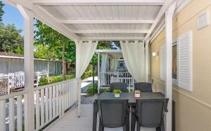 a patio with a table and chairs on a porch at Camping Parco Vacanza Partaccia 2 in Marina di Massa