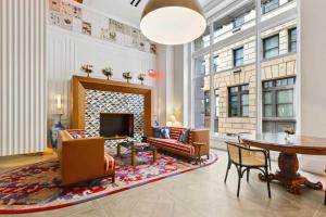 a living room with a fireplace and a table and chairs at CozySuites at Sky Central in Cincinnati