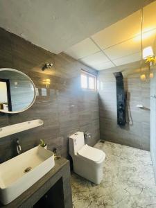 a bathroom with a white toilet and a sink at Can win Resort Yala in Tissamaharama
