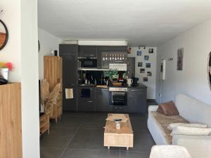 a living room with a couch and a table at Lou soulèu in Cassis +9 photos