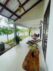 a porch with benches and a wooden table at Can win Resort Yala in Tissamaharama