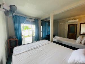 a bedroom with a large bed and a window at Can win Resort Yala in Tissamaharama