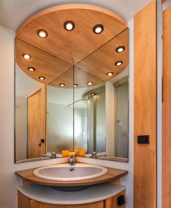 a bathroom with a sink and a large mirror at Camping Parco Vacanza Partaccia 2 in Marina di Massa +58 photos