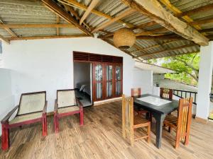 a dining room with a table and chairs at Can win Resort Yala in Tissamaharama +56 photos