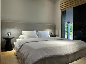 a bedroom with a large white bed and a window at Your Luxury Villa in the South of Jakarta in Samporo +34 photos