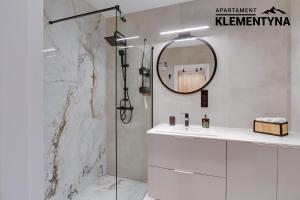 a bathroom with a shower and a sink and a mirror at Klementyna in Bystra