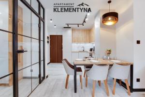 a kitchen and dining room with a wooden table and chairs at Klementyna in Bystra