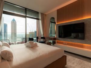 a hotel room with a large bed and a television at Heaven's Dreams Business Bay in Dubai