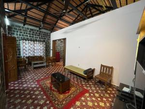a living room with a couch and chairs in a room at Honeycomb Abode in Salem +27 photos