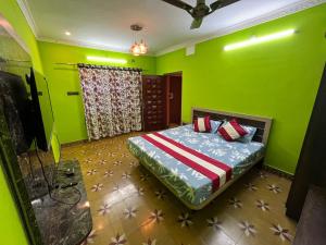 a bedroom with green walls and a bed in it at Honeycomb Abode in Salem