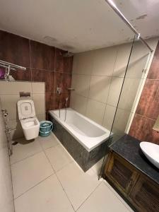 a bathroom with a tub and a toilet and a sink at Honeycomb Abode in Salem