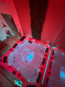 a hot tub in a room with red lights at Rubino Private SPA & Room in Corato