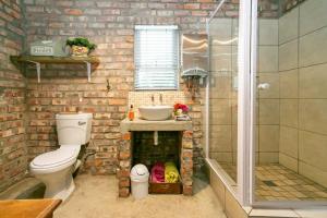a bathroom with a toilet and a sink and a shower at Die Fonteine Country Guesthouse and Glamping in Oudtshoorn +66 photos