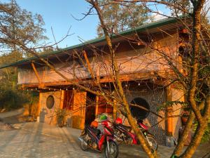 two motorcycles parked in front of a building at Friendly Homestay & Authentic Trekking Tours in Sapa